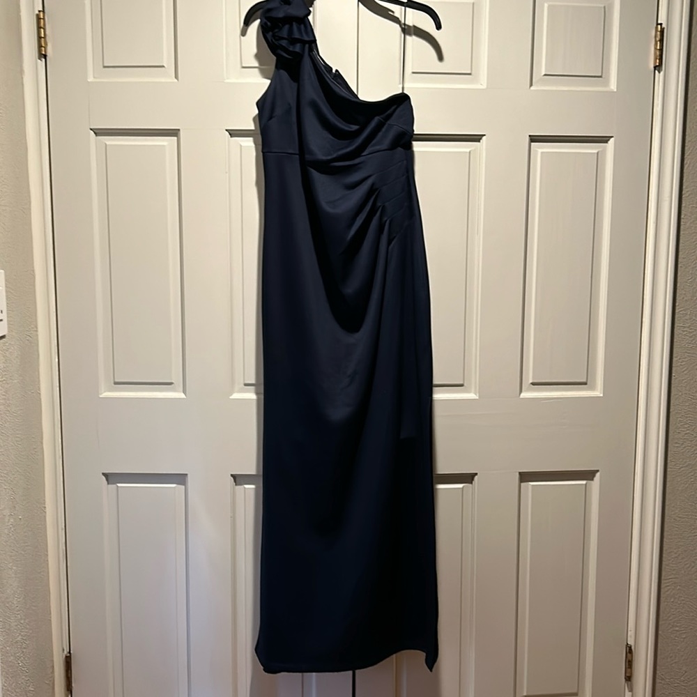 Navy one shoulder dress with flower accent.